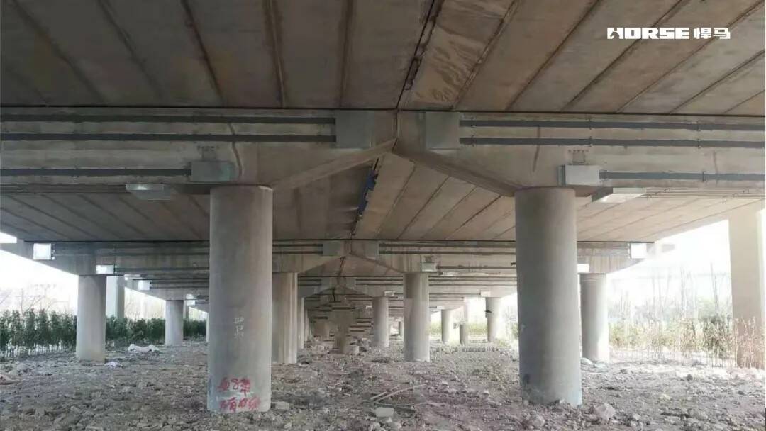 Prestressed CFRP Laminate Reinforcement System for Bridge